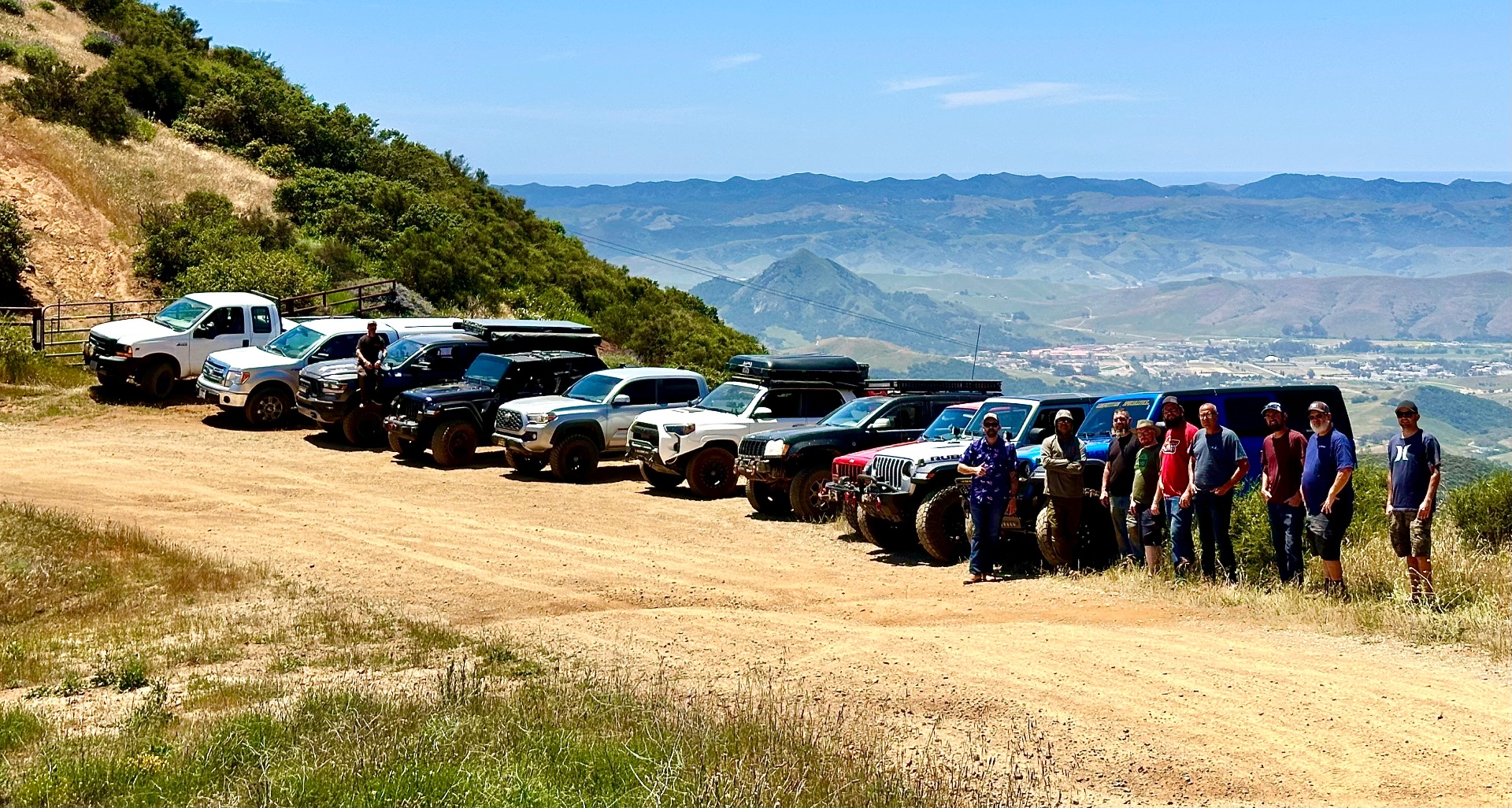 Adventure Squad members lined up with their rigs on a mountain turnout